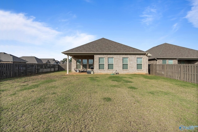 back of property featuring a yard