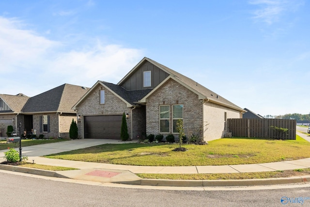 view of front of property with a garage and a front lawn