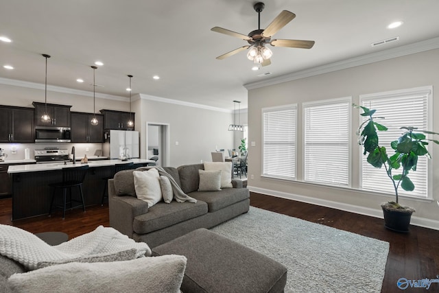 living room featuring ceiling fan, ornamental molding, and dark wood-type flooring