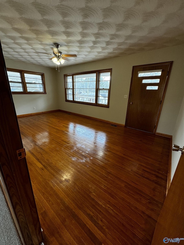 entryway featuring hardwood / wood-style floors, a textured ceiling, and ceiling fan