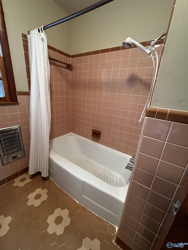 bathroom featuring heating unit, tile walls, and shower / tub combo with curtain