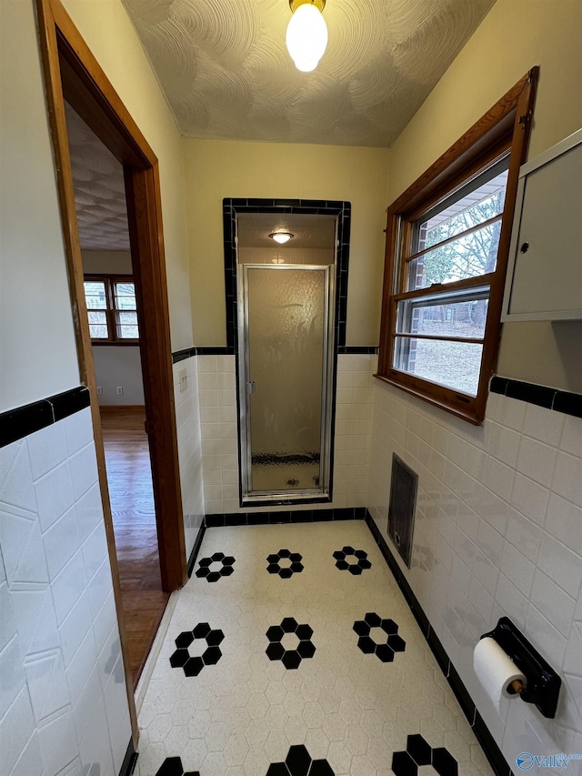 doorway featuring tile walls and a textured ceiling