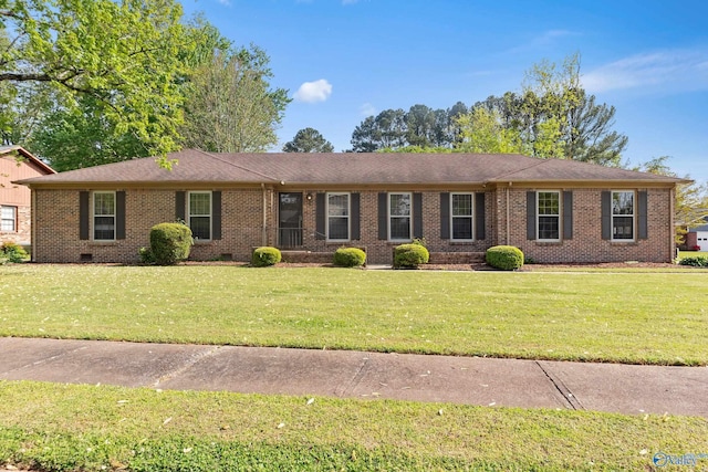 ranch-style home featuring brick siding, crawl space, a front yard, and a shingled roof