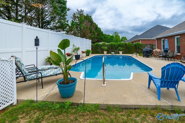 view of pool featuring a patio, a fenced in pool, and a fenced backyard