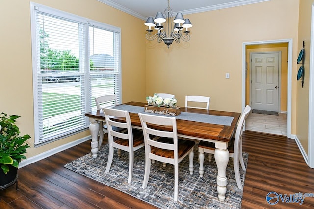 dining space with a chandelier, baseboards, wood finished floors, and crown molding