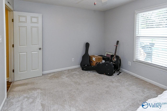 miscellaneous room with a ceiling fan, carpet flooring, and plenty of natural light