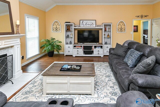 living area with a fireplace with flush hearth, wood finished floors, ornamental molding, and baseboards