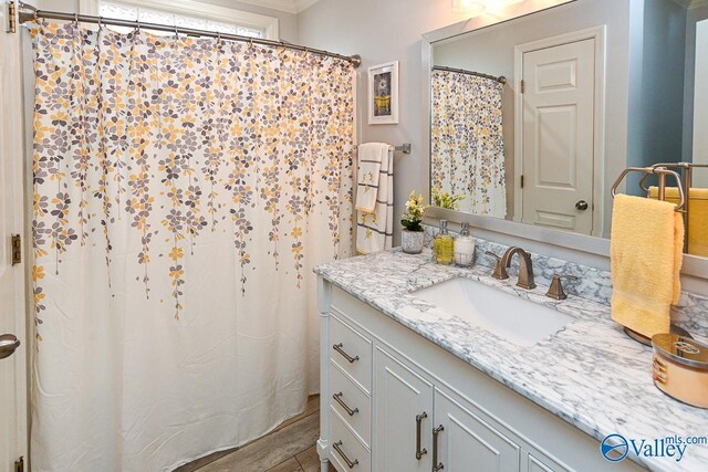 bathroom featuring ornamental molding and vanity