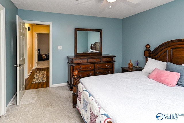 carpeted bedroom featuring baseboards and a ceiling fan