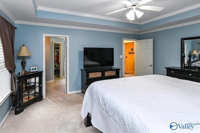 bedroom featuring baseboards, a ceiling fan, crown molding, and light colored carpet