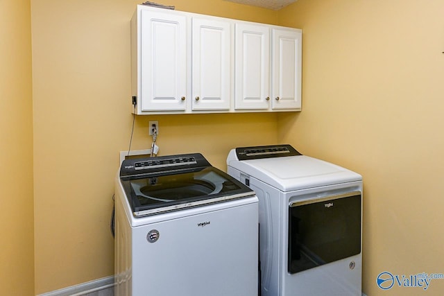 laundry area with cabinet space and washing machine and dryer