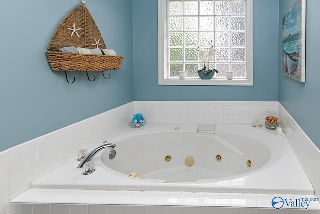full bathroom featuring a tub with jets