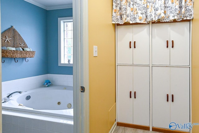 full bathroom featuring a tub with jets and ornamental molding