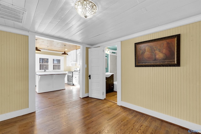 unfurnished living room featuring hardwood / wood-style floors, ceiling fan, and wood ceiling