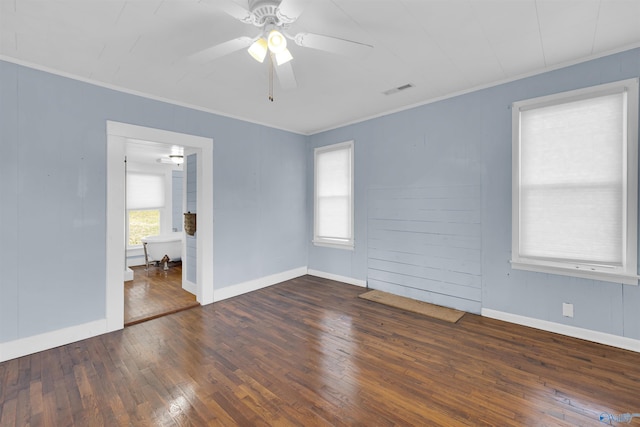 unfurnished room with ceiling fan, crown molding, and dark wood-type flooring