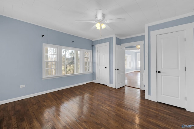 unfurnished bedroom featuring ceiling fan, dark hardwood / wood-style flooring, and ornamental molding