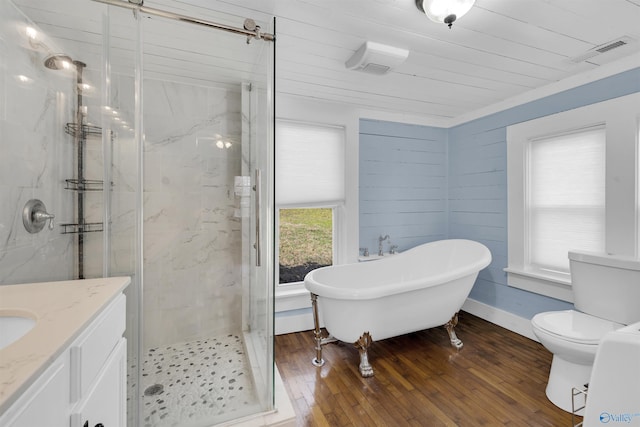 full bathroom with hardwood / wood-style floors, vanity, toilet, and independent shower and bath