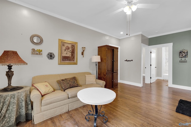 living room featuring ceiling fan, hardwood / wood-style floors, and crown molding