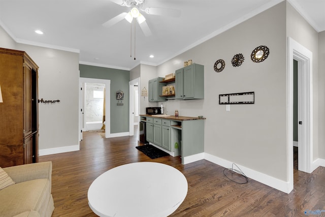 interior space with ceiling fan, dark hardwood / wood-style flooring, and crown molding