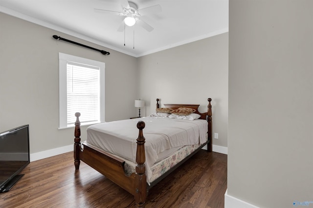 bedroom with ceiling fan, crown molding, and dark wood-type flooring