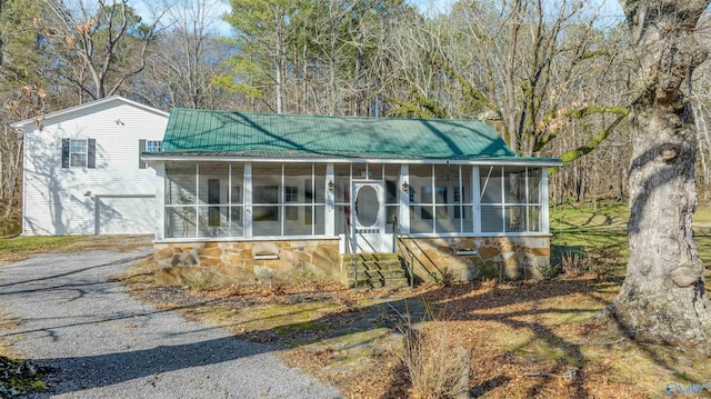 view of front of home with a sunroom