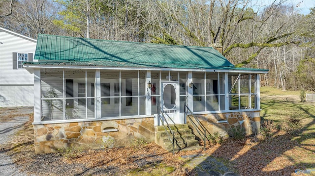 exterior space featuring a sunroom