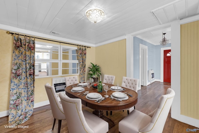 dining room with heating unit, crown molding, dark hardwood / wood-style flooring, and wood ceiling