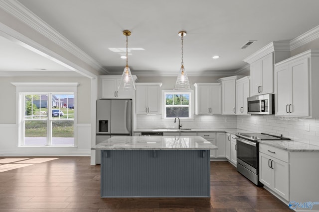 kitchen featuring white cabinetry, crown molding, a kitchen island, dark wood-type flooring, and appliances with stainless steel finishes