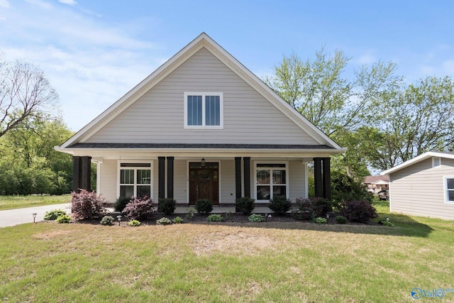 view of front of house with a front yard and covered porch