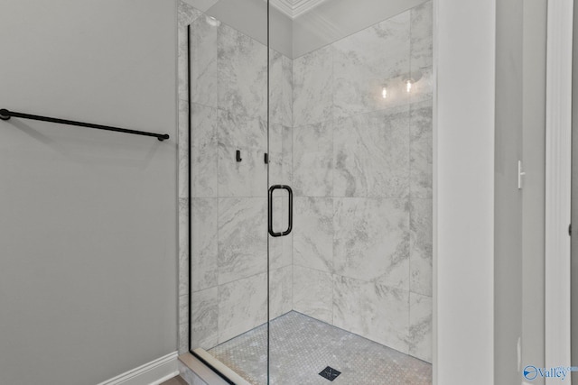 bathroom with baseboards and a shower stall