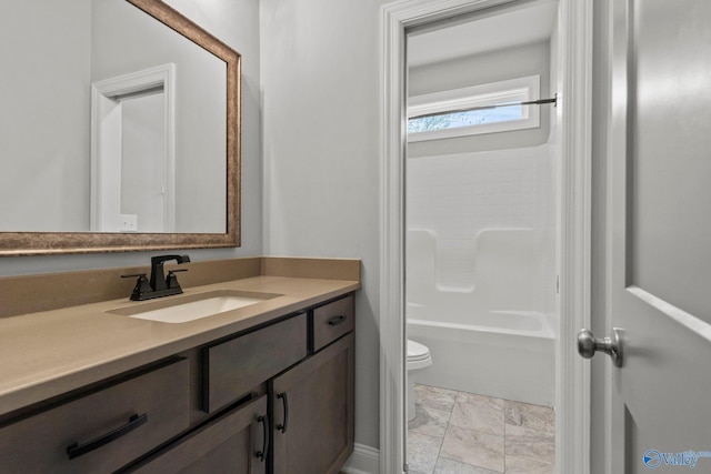 full bathroom with toilet, vanity, and washtub / shower combination