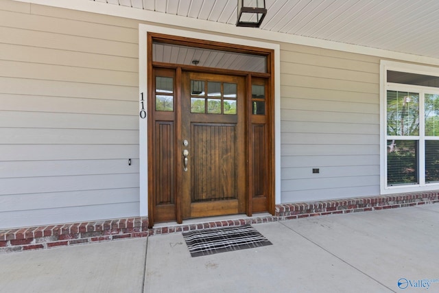 doorway to property featuring a porch