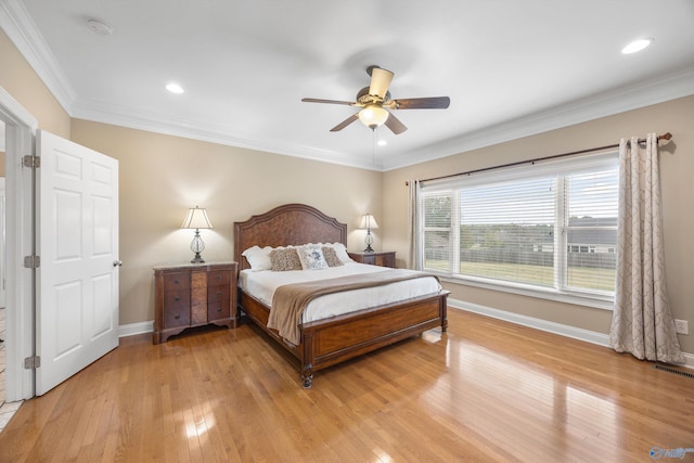 bedroom featuring ornamental molding, light hardwood / wood-style floors, and ceiling fan