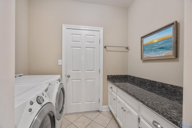 clothes washing area featuring cabinets, light tile patterned flooring, and separate washer and dryer