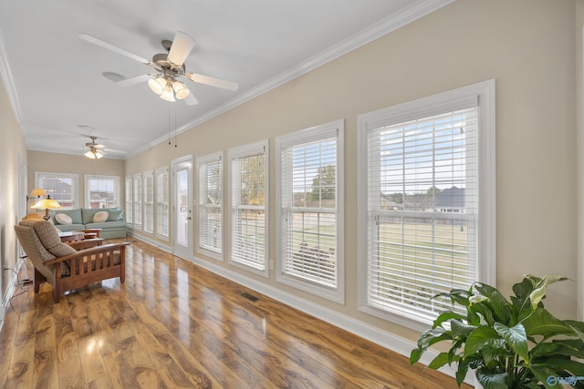 sunroom with ceiling fan and plenty of natural light