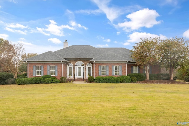 single story home featuring a front yard and french doors