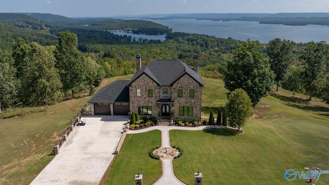 view of front facade with a front yard and a water view