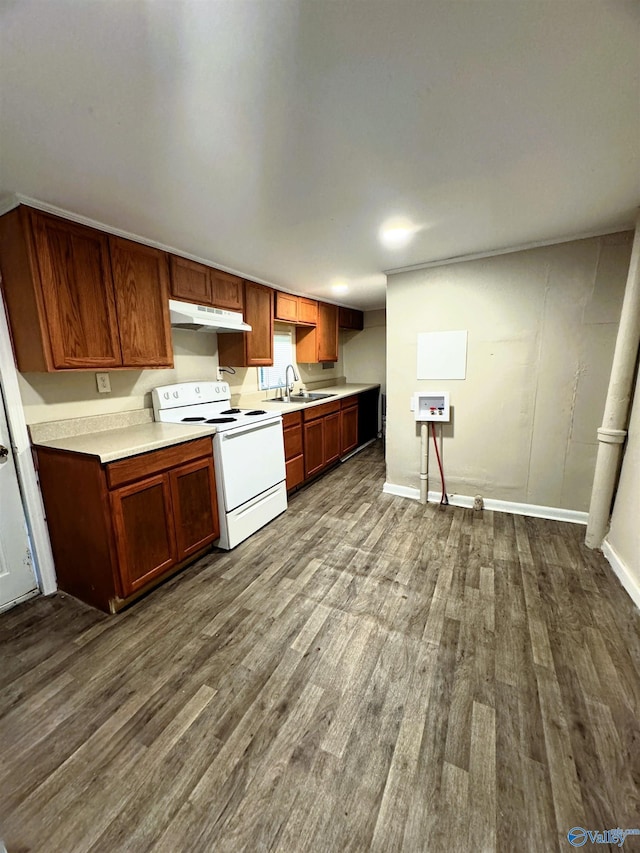 kitchen with under cabinet range hood, light countertops, white electric stove, and dark wood-type flooring