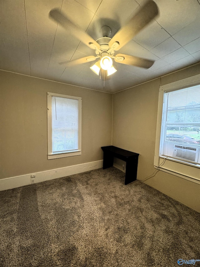 empty room with baseboards, ceiling fan, and carpet flooring