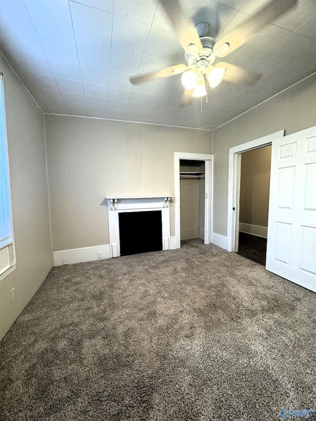 unfurnished bedroom with a ceiling fan, baseboards, carpet, and a closet