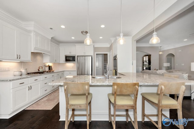 3011 Chimney Cove Cir, Brownsboro, AL 35741 - kitchen with appliances with stainless steel finishes, a sink, arched walkways, white cabinets, and recessed lighting