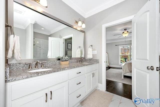 3011 Chimney Cove Cir, Brownsboro, AL 35741 - ensuite bathroom with marble look tile flooring, double vanity, crown molding, baseboards, and a shower