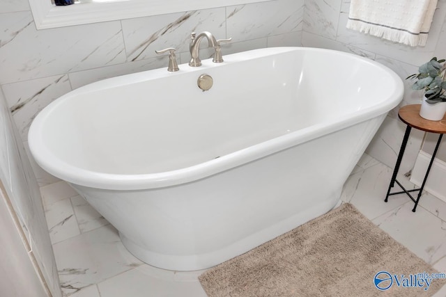 3011 Chimney Cove Cir, Brownsboro, AL 35741 - bathroom featuring marble finish floors, a soaking tub, and tile walls
