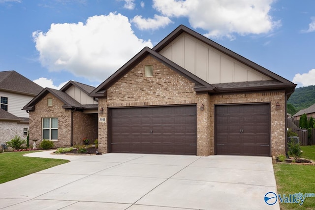 3011 Chimney Cove Cir, Brownsboro, AL 35741 - craftsman-style house with brick siding, board and batten siding, a garage, and driveway