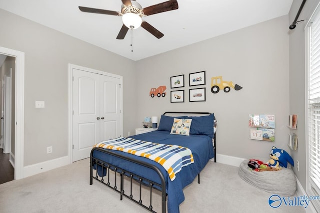 3011 Chimney Cove Cir, Brownsboro, AL 35741 - carpeted bedroom featuring a closet, baseboards, and ceiling fan