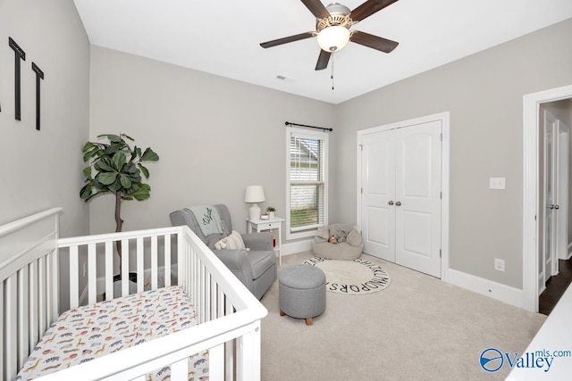 3011 Chimney Cove Cir, Brownsboro, AL 35741 - carpeted bedroom with a closet, a nursery area, a ceiling fan, and baseboards