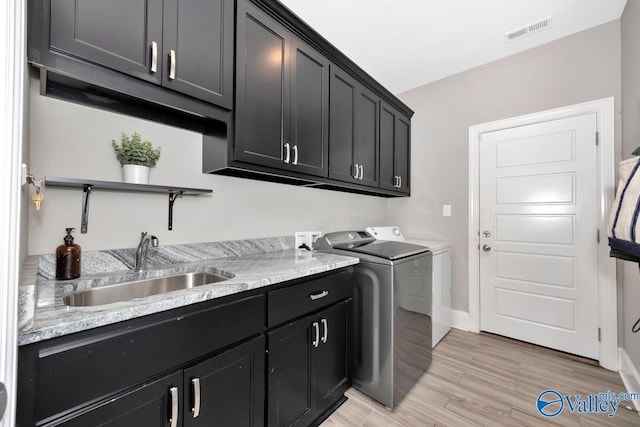 3011 Chimney Cove Cir, Brownsboro, AL 35741 - washroom with cabinet space, washer and dryer, light wood-style floors, and baseboards