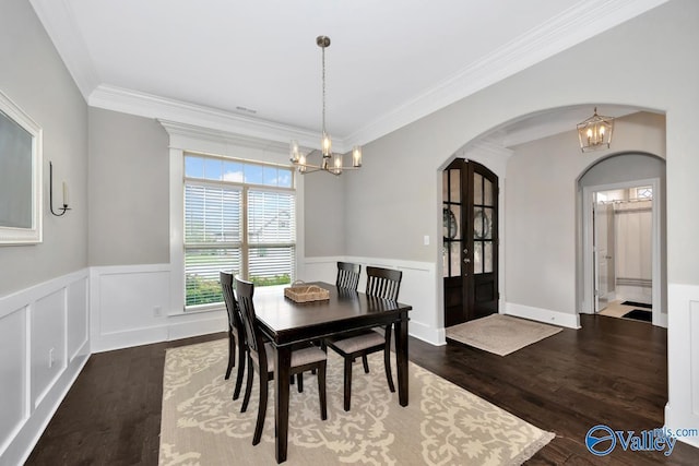 3011 Chimney Cove Cir, Brownsboro, AL 35741 - dining room with a chandelier, arched walkways, crown molding, wood finished floors, and french doors