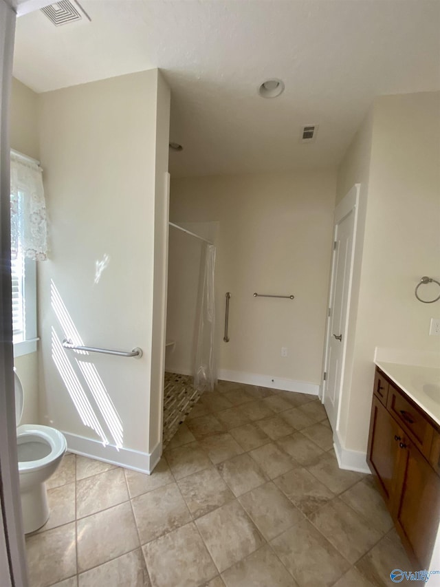 full bathroom featuring a stall shower, visible vents, vanity, and baseboards