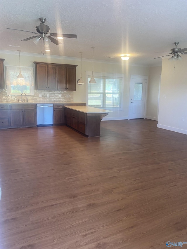 kitchen with a peninsula, a sink, dark wood finished floors, and dishwasher